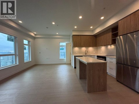 A modern kitchen with wooden cabinets and stainless steel appliances.