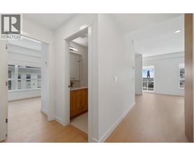 A realtor logo is on the top left of a white interior space.