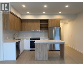 A modern kitchen with wooden cabinets and stainless steel appliances.