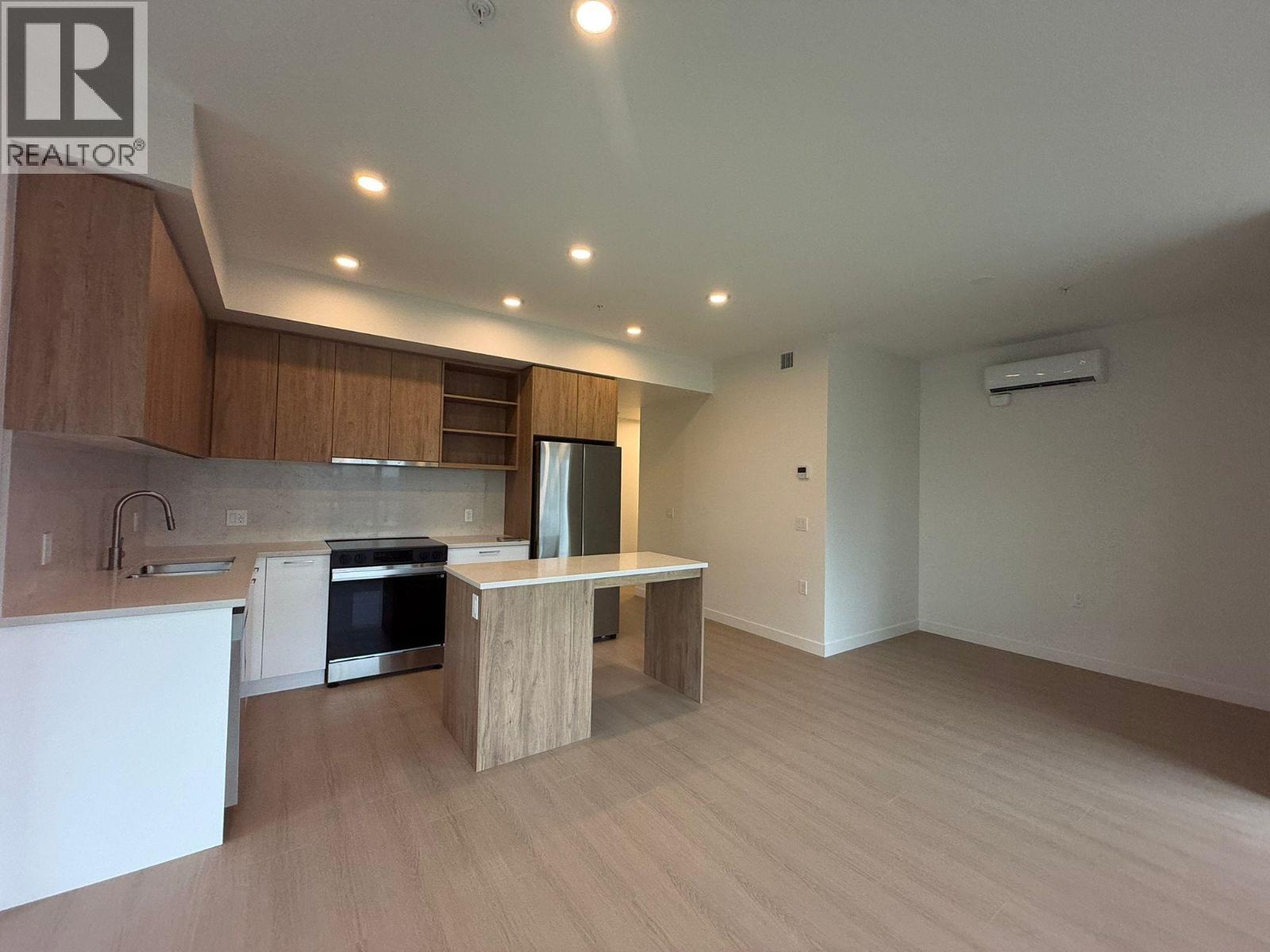 A modern kitchen with wooden cabinets and a white countertop.