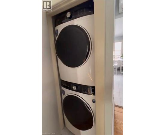 A white washing machine is installed in a narrow space.