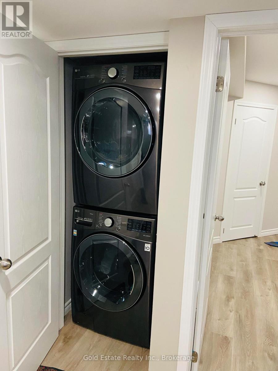 A washer and dryer are stacked in a small space.