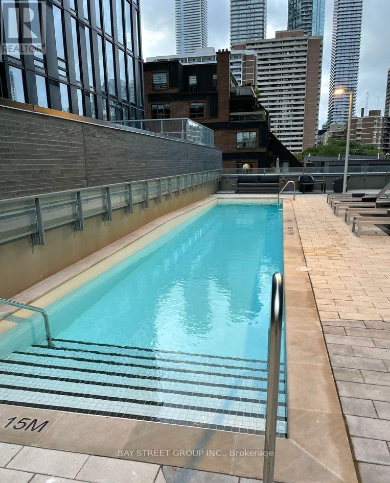 A swimming pool on a rooftop with a 15M marker.