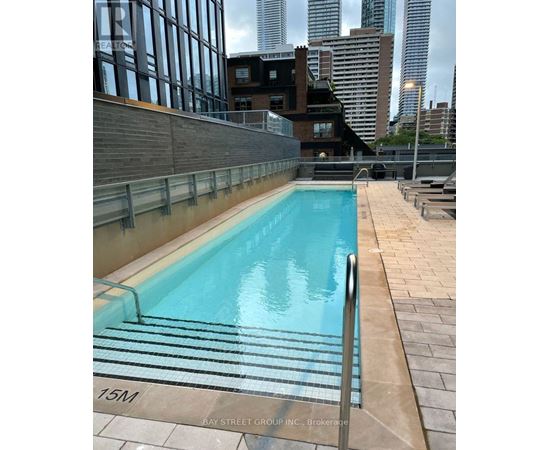 A swimming pool on a rooftop with a 15M marker.