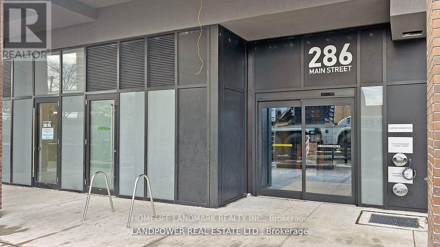 The image shows the front of a real estate office located at 286 Main Street.