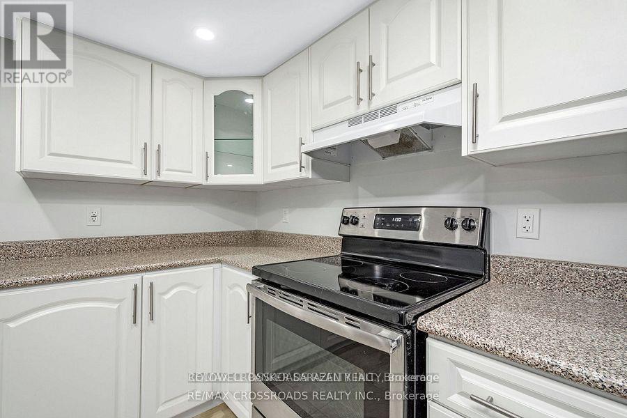 A kitchen with white cabinets and a granite countertop.