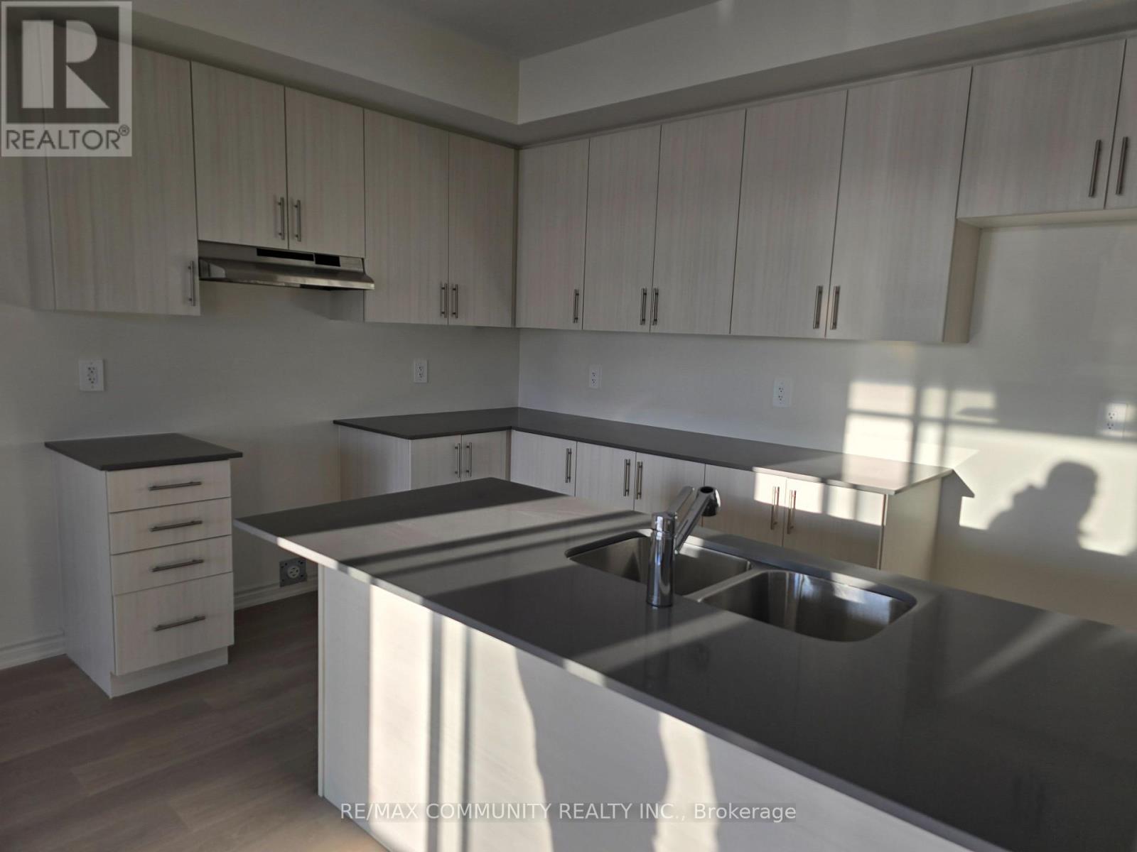 A kitchen with a sink and cabinets.
