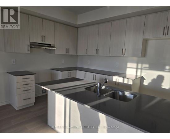 A kitchen with a sink and cabinets.