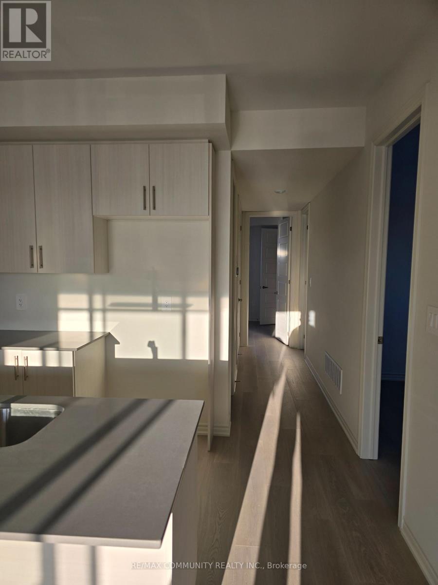 A realtor photo of a modern kitchen and hallway.