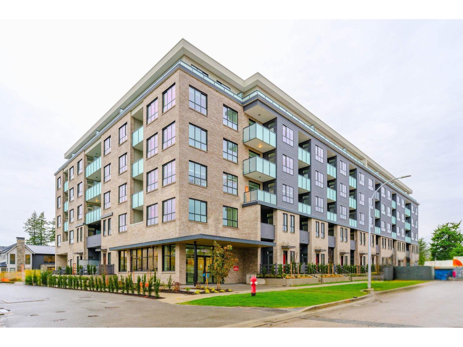 A large, modern building with a mix of beige and blue tones.
