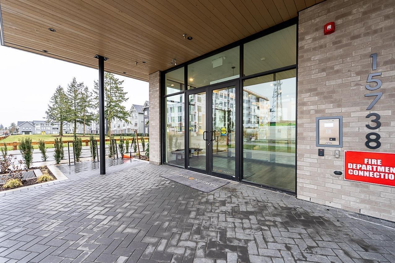 The image shows a building entrance with a glass door and a sign that reads "Fire Department Connection".