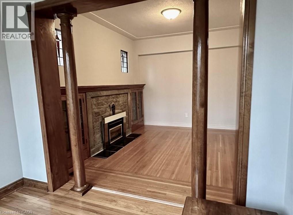 A room with a fireplace and wooden floors.