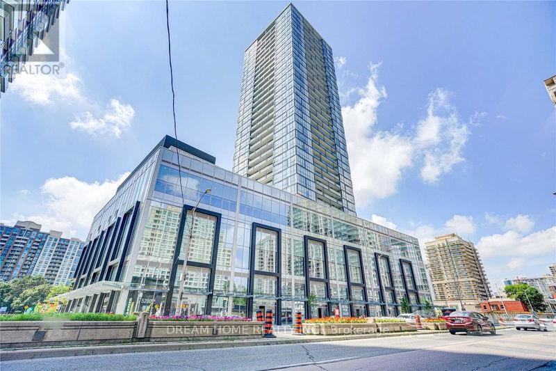 A modern glass building with the words "Dream Home" on the front.