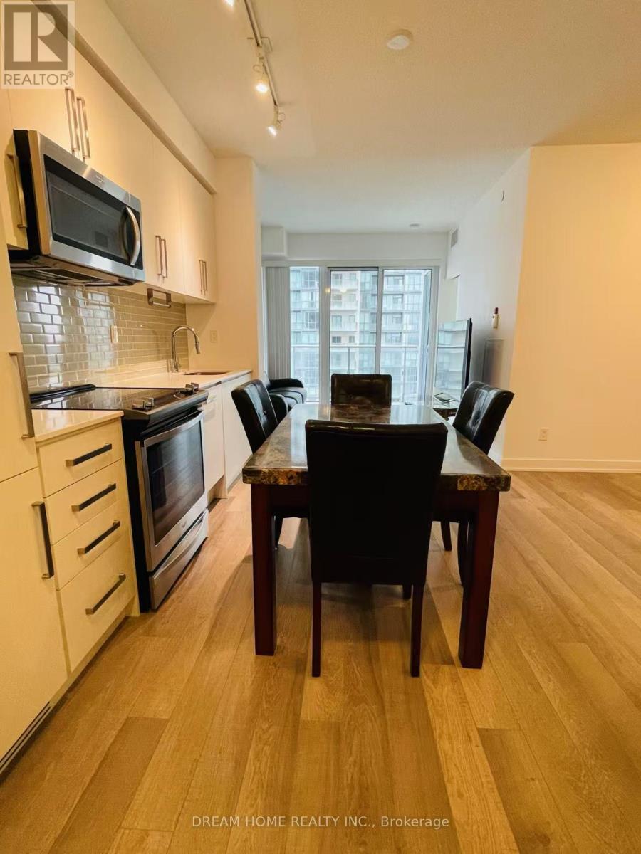 A kitchen with a table and chairs in front of a window.