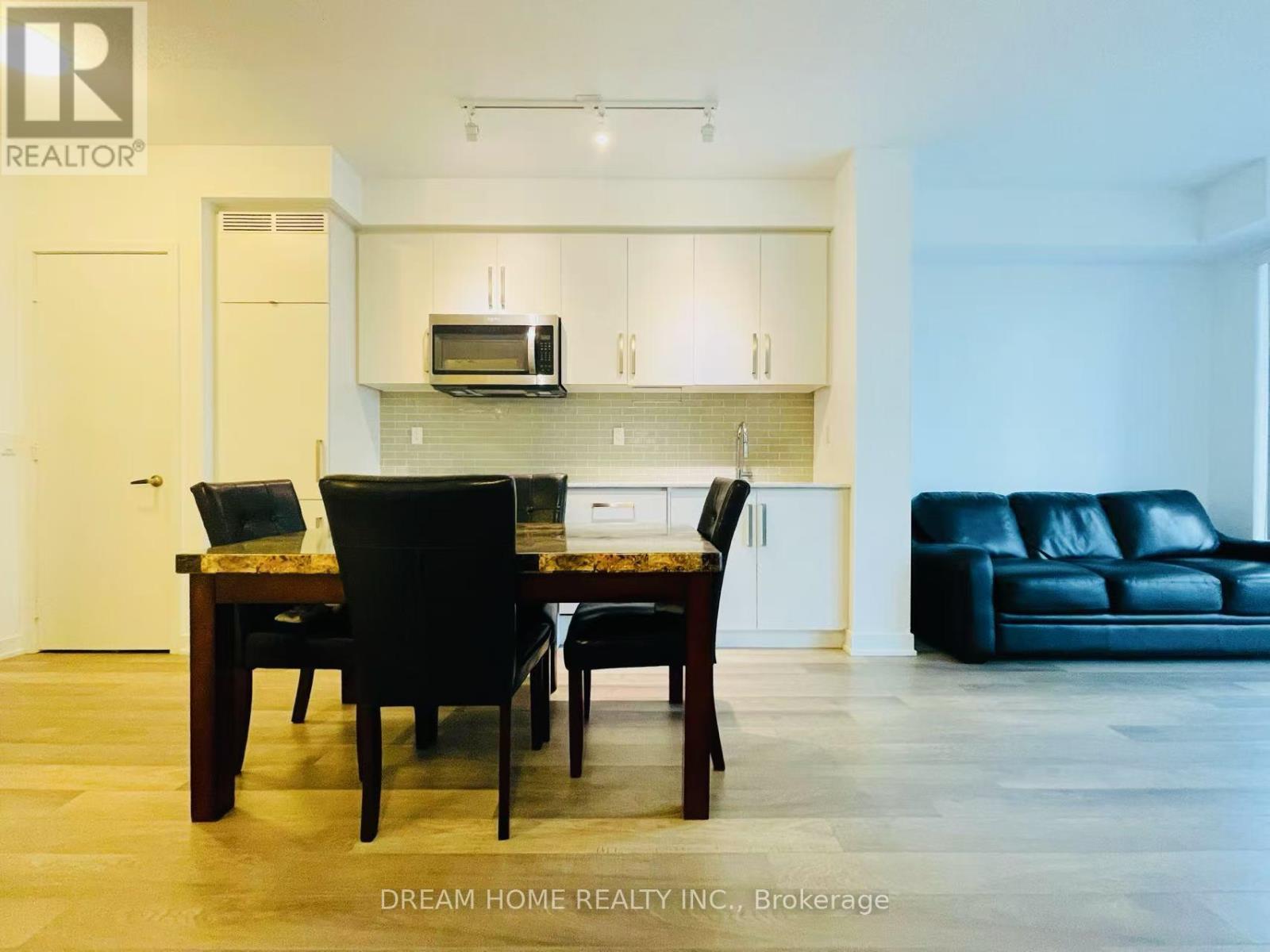 A modern dining room with a wooden table and chairs.