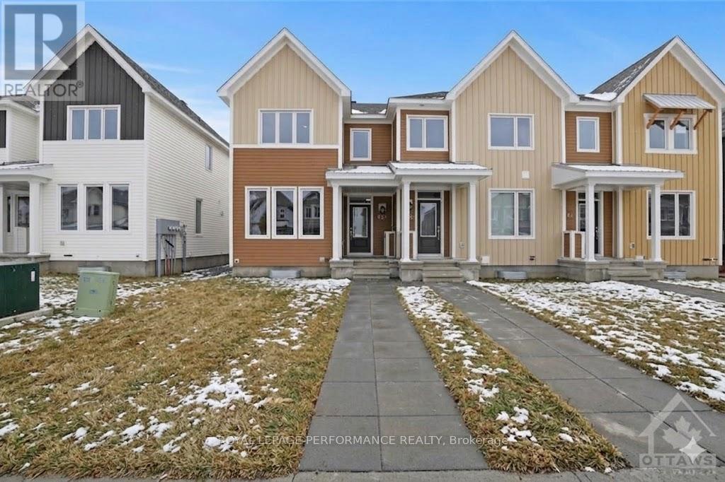 A real estate photo of a row of houses with the text "Performance Realty, Brooks" on the bottom.