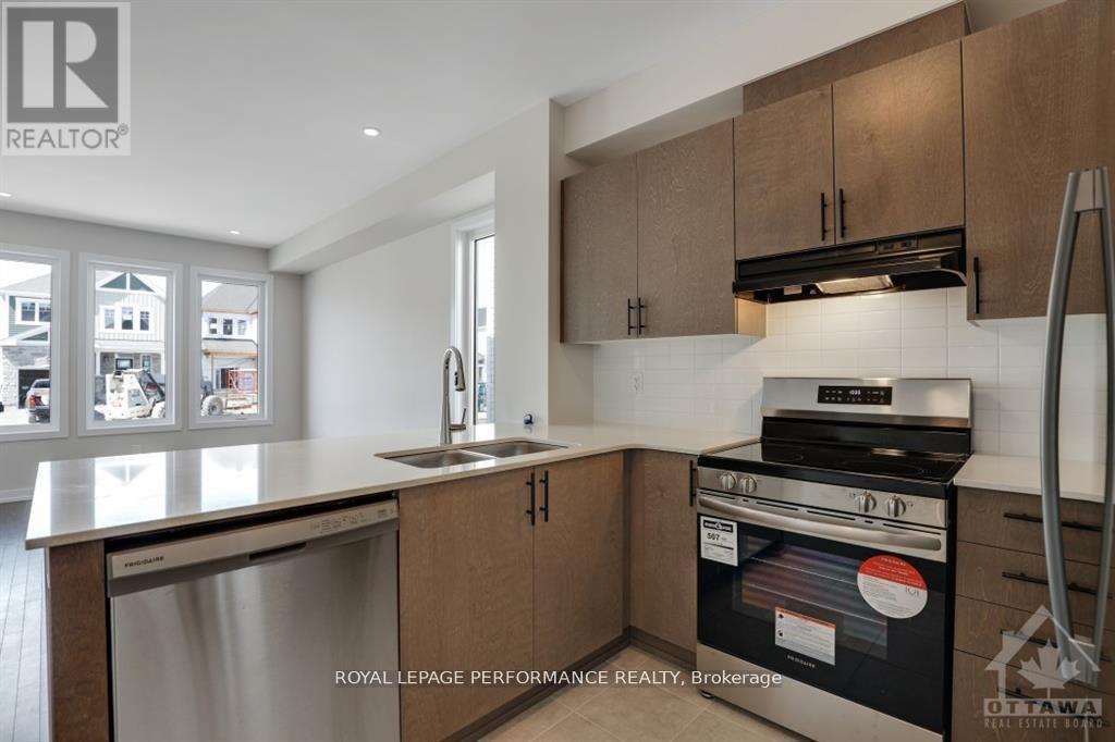 A kitchen with a stove top oven and a dishwasher.