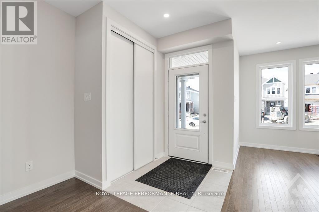 A white door with a glass window is in the middle of a room.