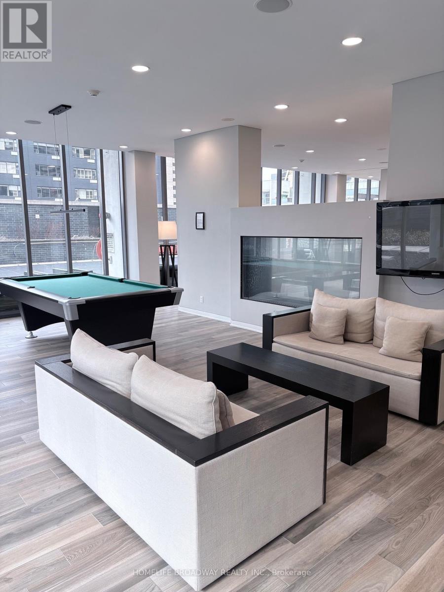 A modern living room with a pool table and a television.