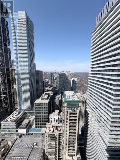 A cityscape with tall buildings and a clear sky.
