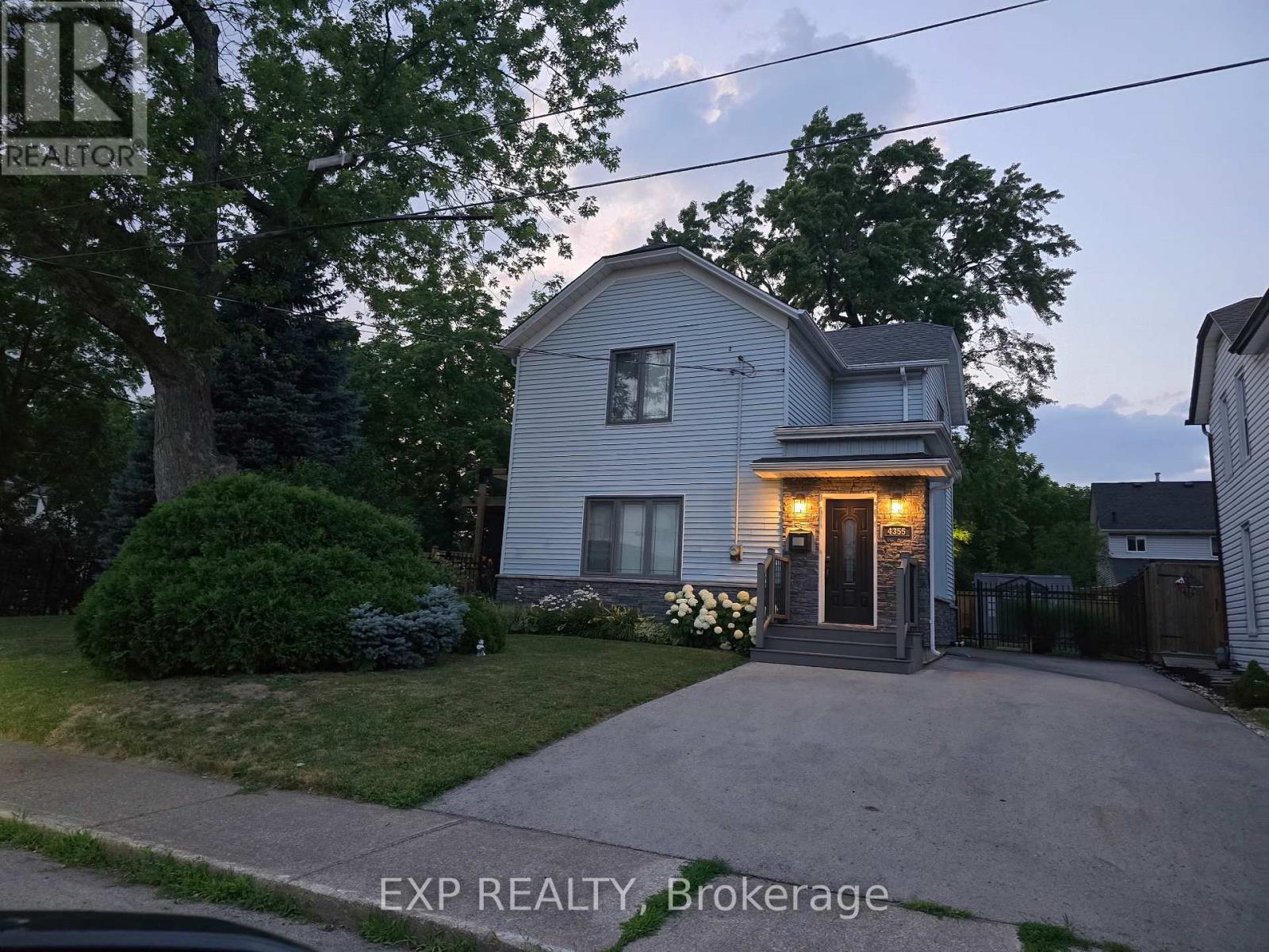 A house with a grey exterior and a small front yard.