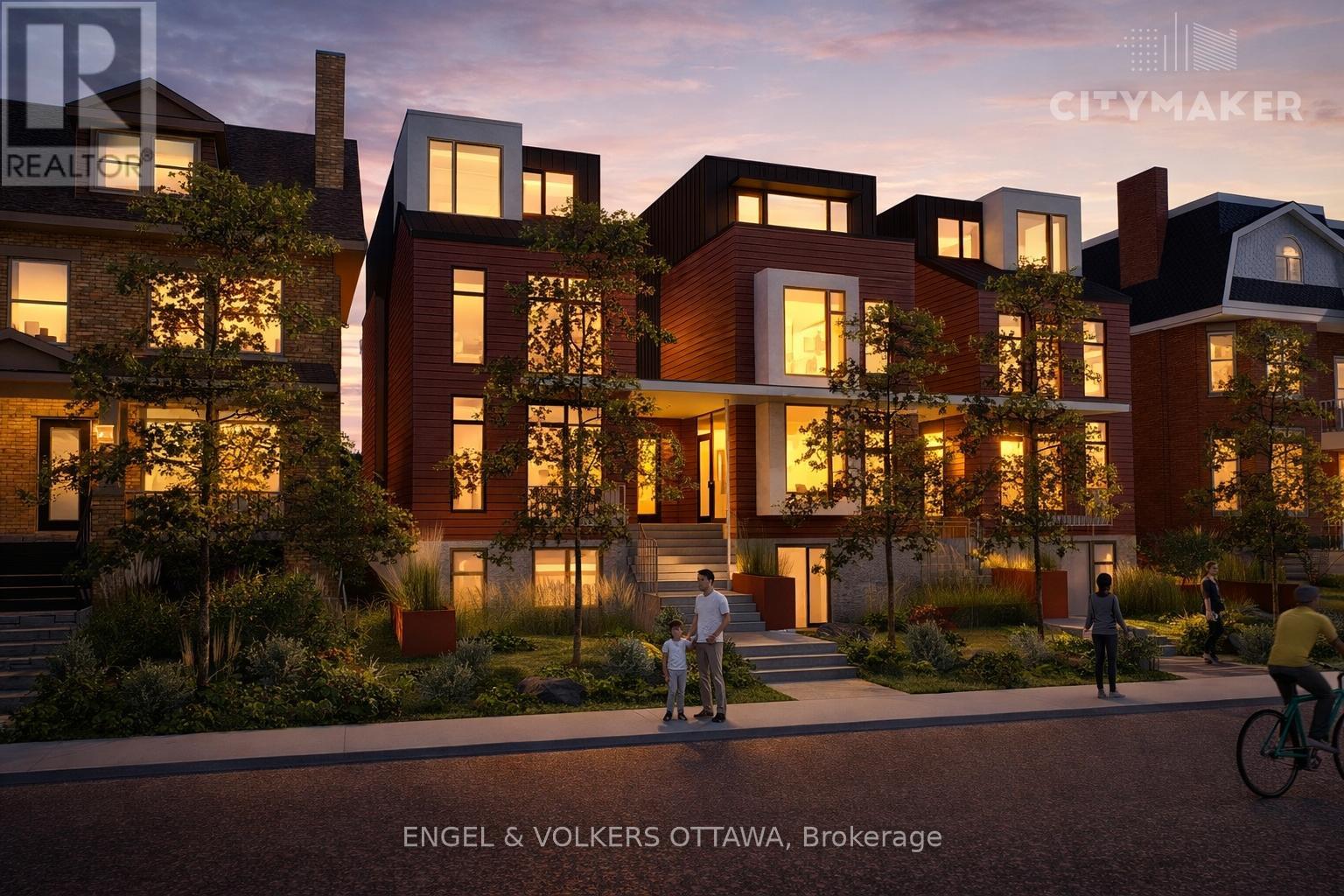 A modern residential building with people walking and cycling in front.