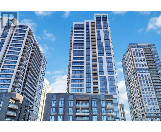 A cityscape with tall buildings and a clear blue sky.