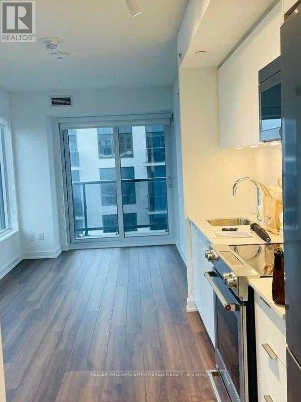 A kitchen with a sink, stove, and oven.