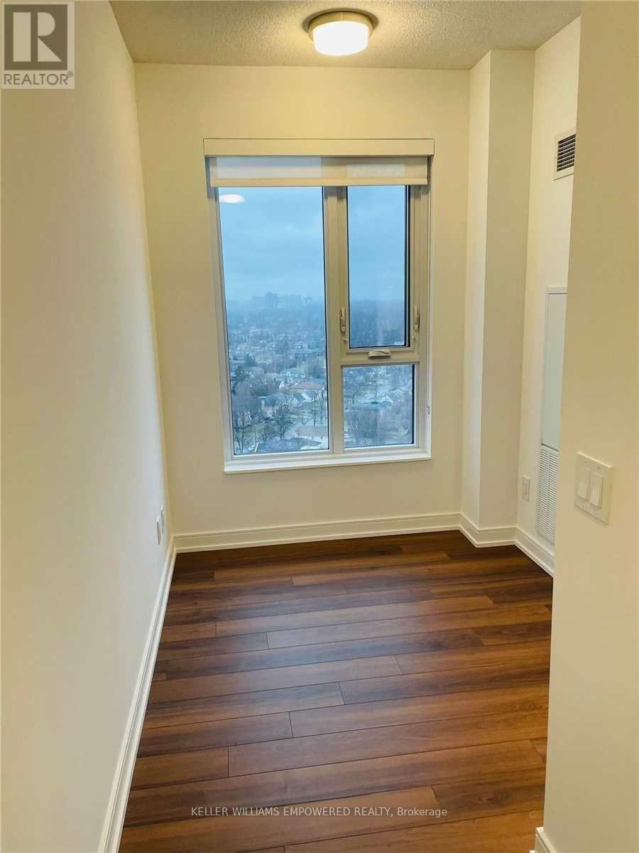 A room with a window overlooking a cityscape.