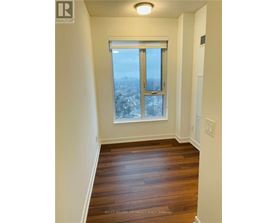 A room with a window overlooking a cityscape.