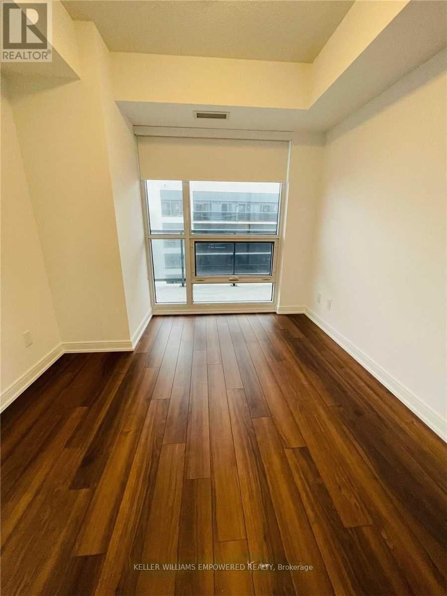 A room with a wood floor and a window.