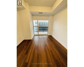 A room with a wood floor and a window.