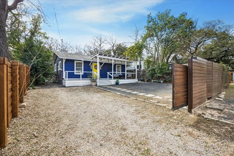 A blue house with a yellow sign on the front.