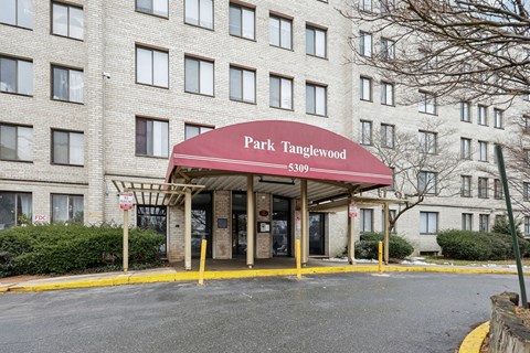 The front of a building with a red awning that says Park Tanglewood.