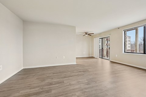 A spacious room with a ceiling fan and sliding glass doors.