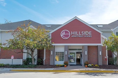 The front of a building with the words Hillside Apartment Homes on it.