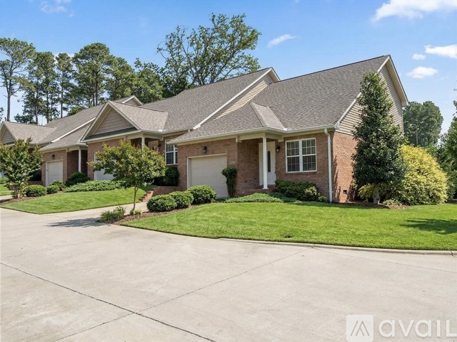 A house with a driveway in front of it.