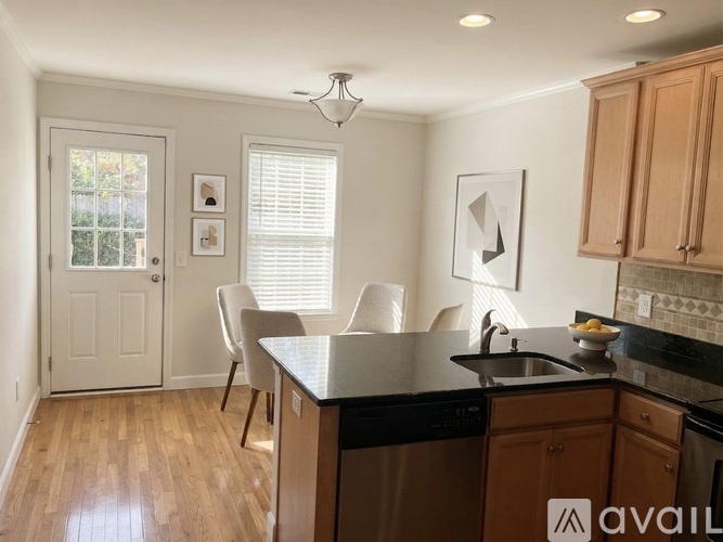 A kitchen with wooden cabinets and a black countertop.