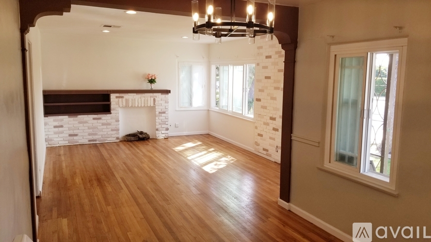 A room with wooden floors and a chandelier.