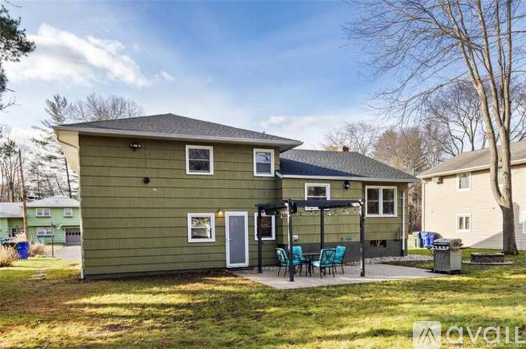 A house with a green exterior is for sale.