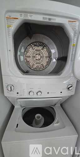 A front-loading washing machine with the door open.