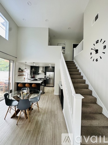 A living room with a dining table and chairs.