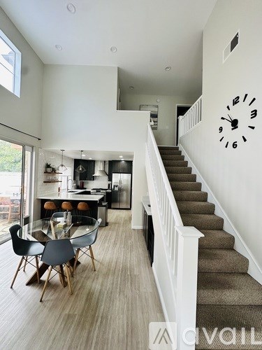 A living room with a dining table and chairs.