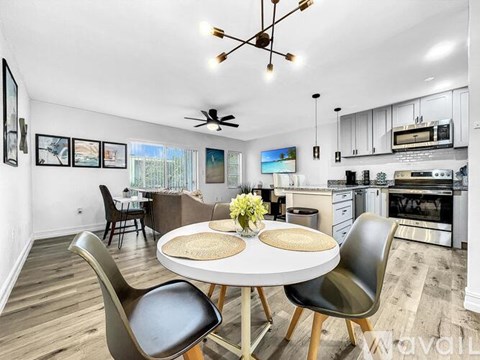 A modern dining room with a round table and chairs.