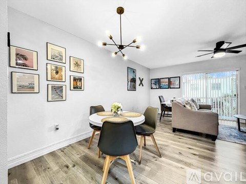 A living room with a dining table and chairs.