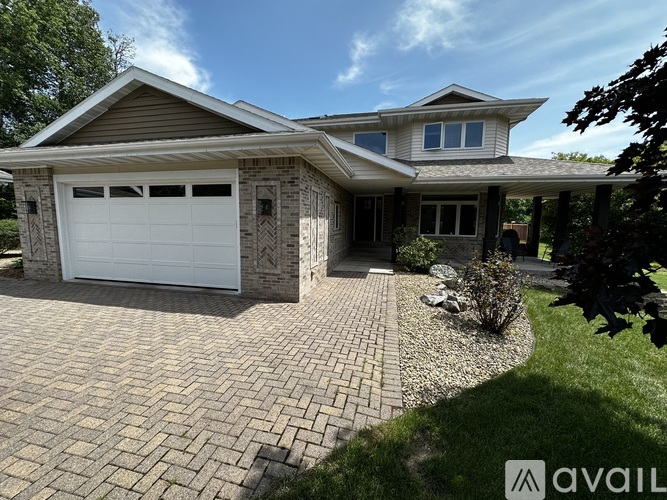 A house with a white garage door is for sale.