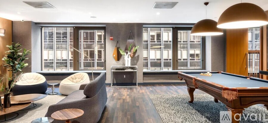 A room with a pool table and a couch.