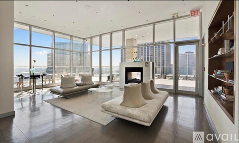 A living room with a white couch and a fireplace.