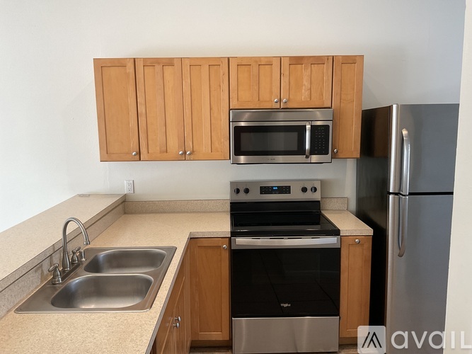 A kitchen with wooden cabinets and stainless steel appliances.