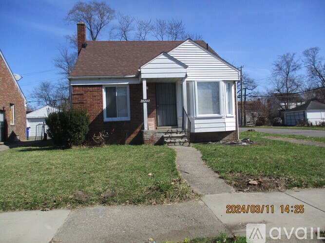 A small house with a brick chimney and a white porch.